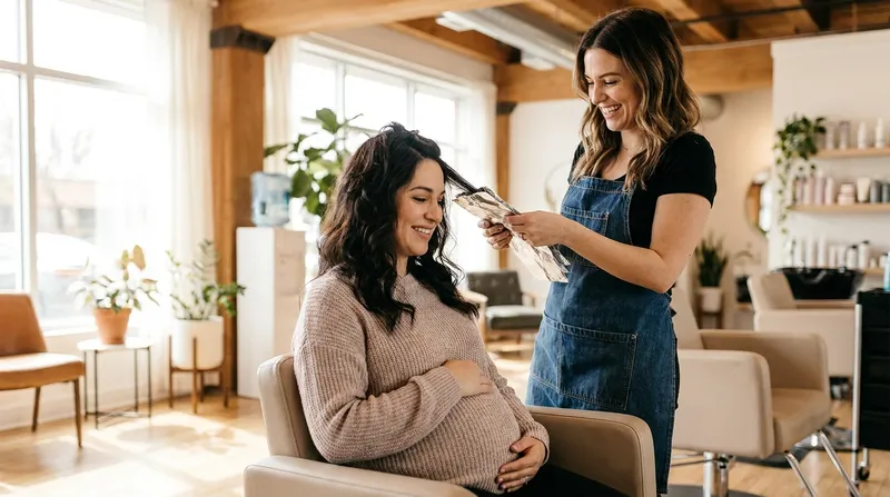 Pregnant woman getting foil highlights applied by a stylist in a bright hair salon